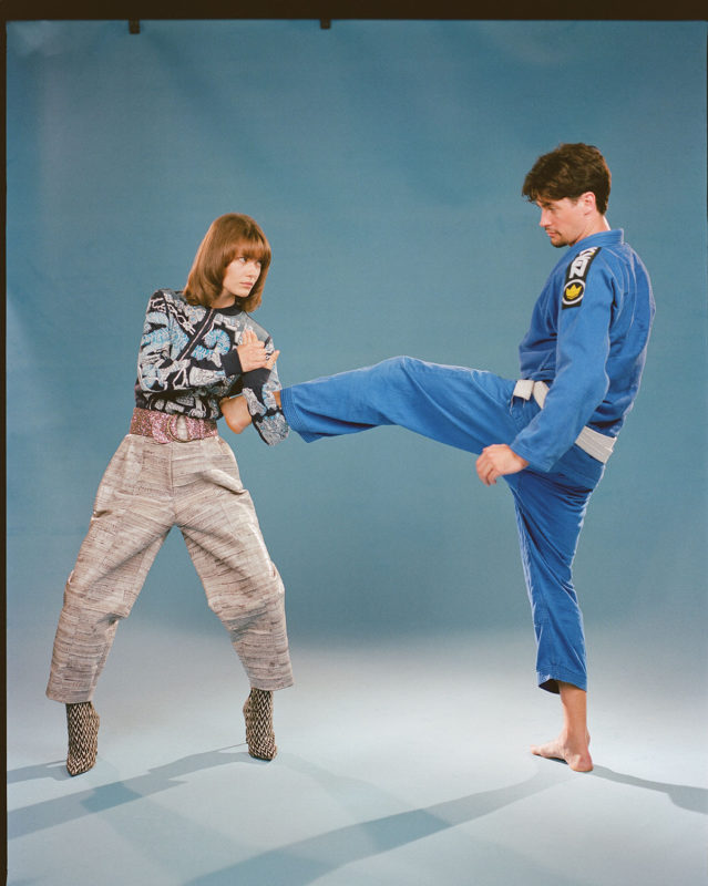 FROM LEFT, ZIPPED SHIRT HERMÈS, TROUSERS KRIZIA, BELT STYLIST'S OWN, SHOES MARIO VALENTINO, CHRISTOPHER WEARS HIS OWN JIU JITSU OUTFIT