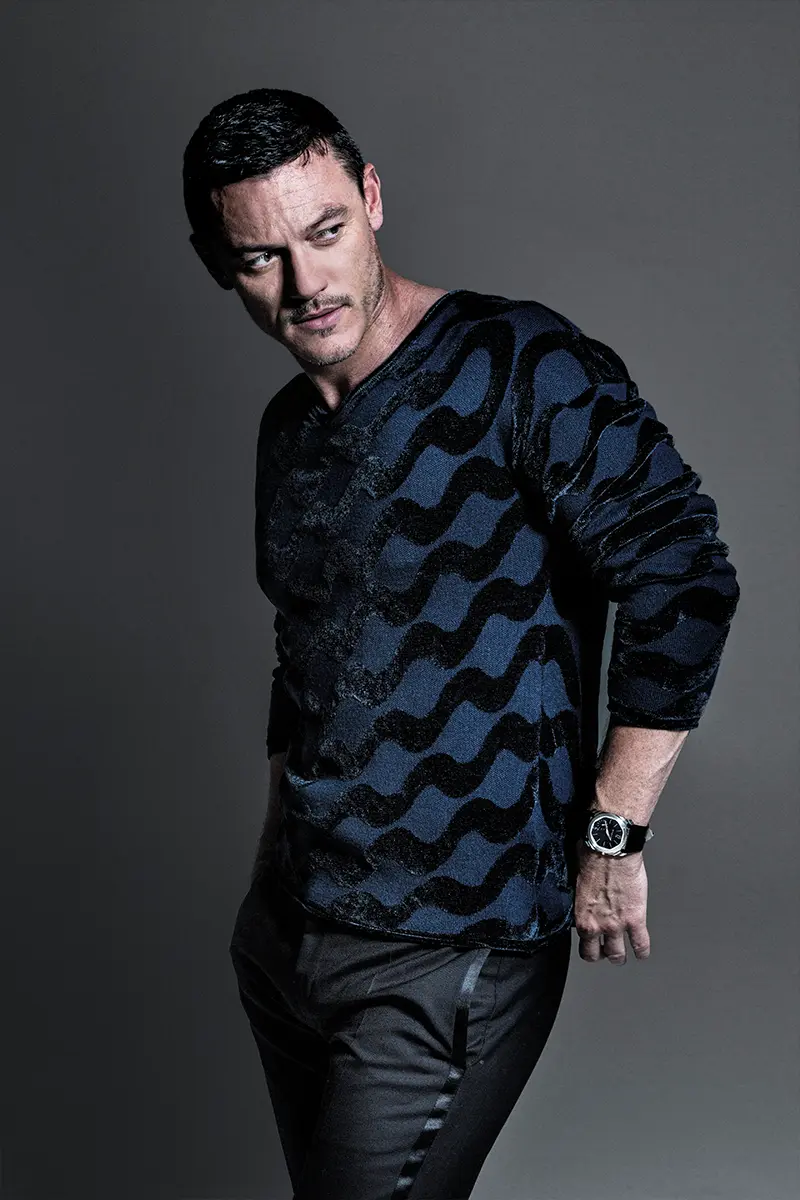 Luke Evans by Avedon, Lampoon Issue 7. Sweater and pants Giorgio Armani, Octo Finissimo watch Bvlgari