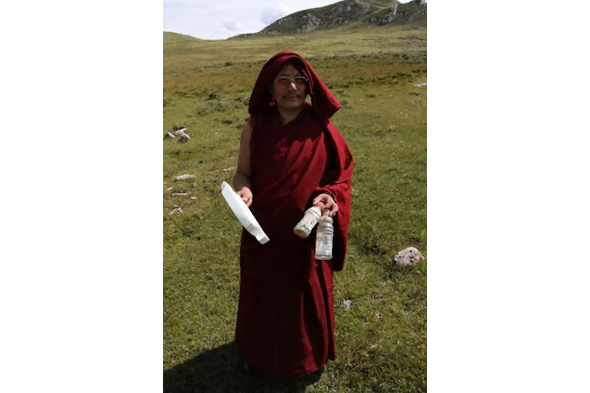 A Tibetan monk collecting garbage