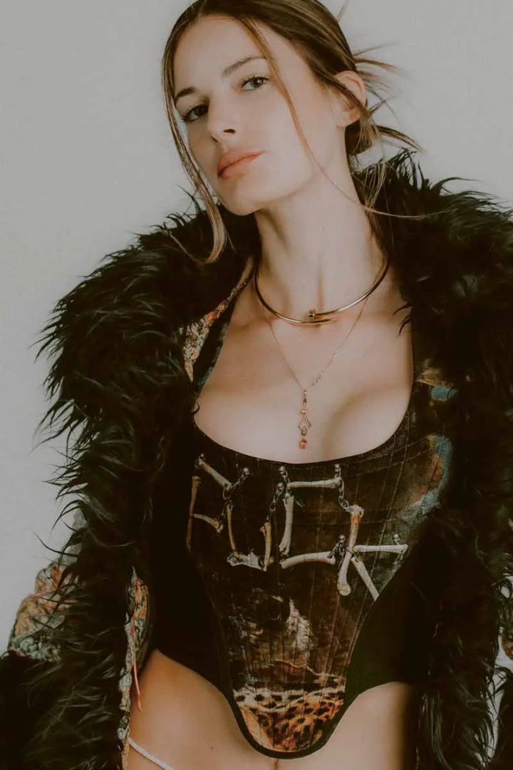 Coat Louis Vuitton, corset Vivienne Westwood, necklace Cartier, necklace talents own