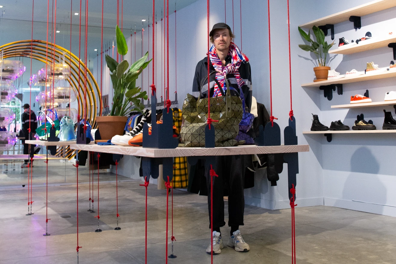 Henrik Vibskov in between the displays inside his concept store in Copenhagen