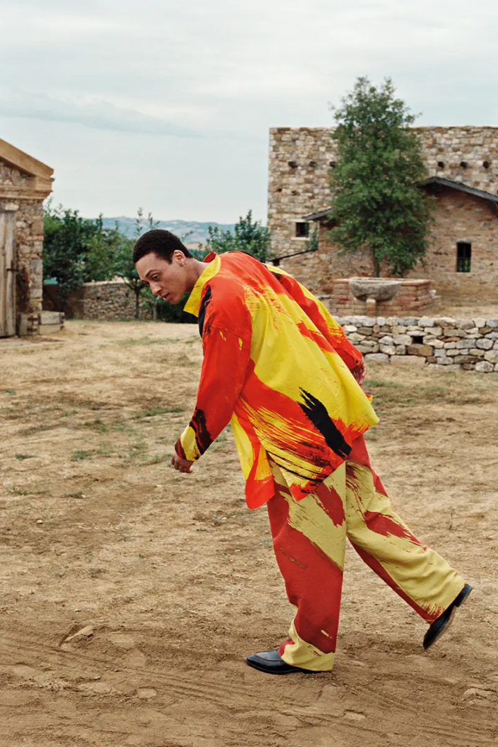 Earl wears shirt and pants ISSEY MIYAKE, shoes PAUL SMITH, earring model's own Photography Luke Wassmann