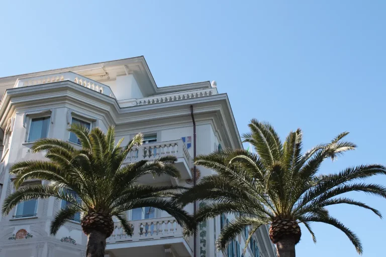 Side view of Grand Hotel Miramare facade with palm trees