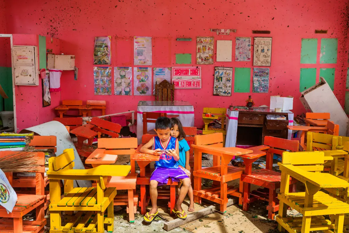 A family picture of happier times lies in the sand outside of a destroyed house, Bohol, Philippine, David Hogsholt Panos Pictures