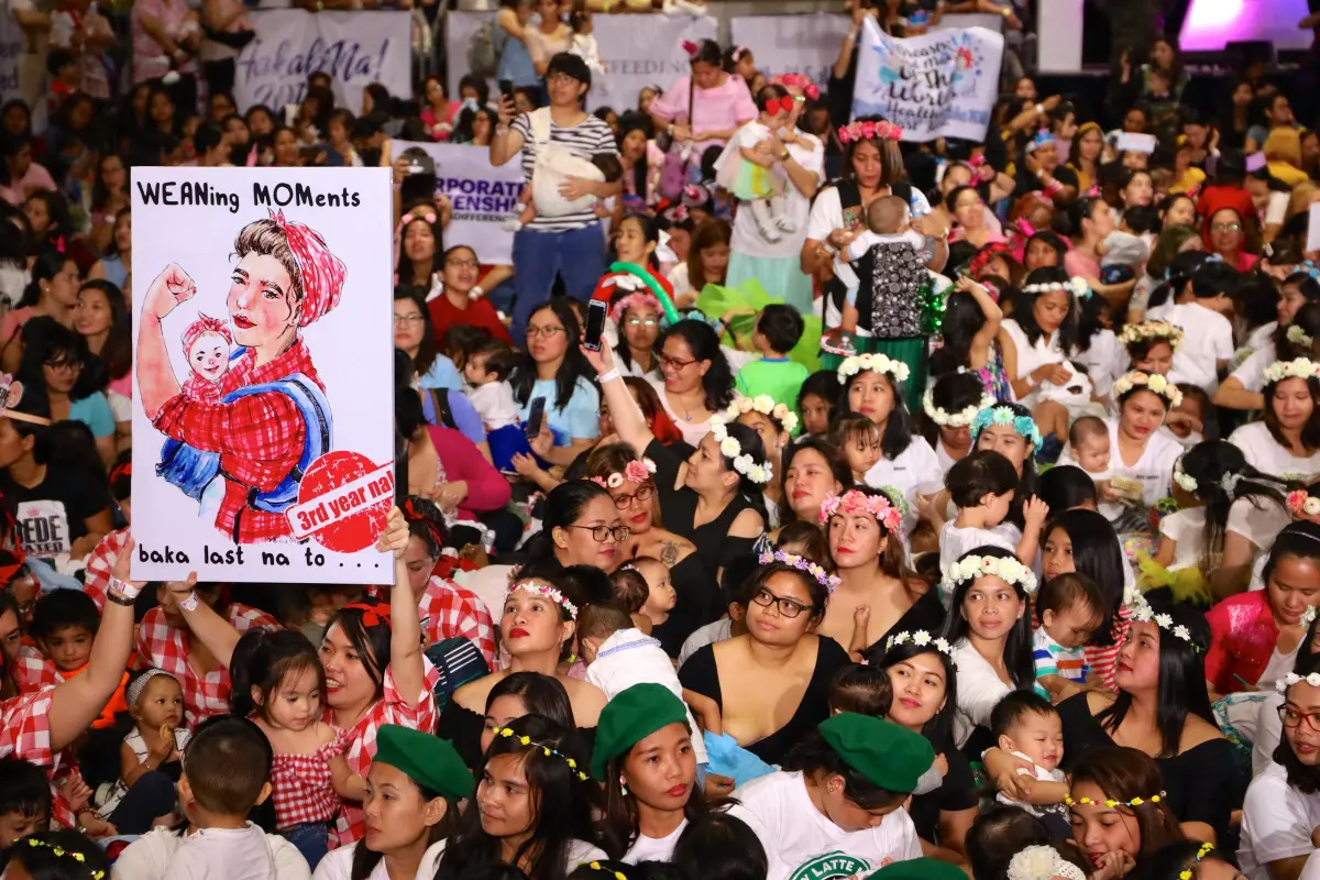 Philippines Women and children hold up version of 'Rosie the Riveter' at the 'Hakab Na!' (Big Latch On!), an annual event promoting breast feeding that draws over 2000 mothers accompanied by their husbands and children