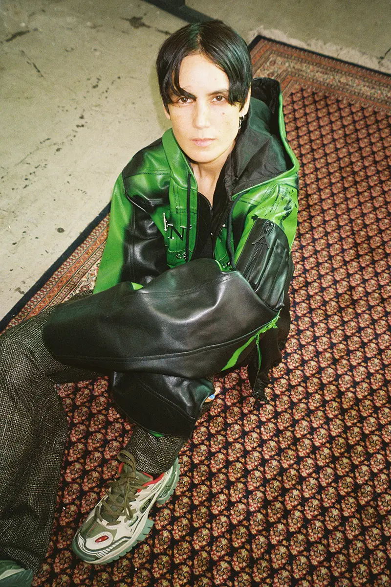 Lampoon, Kim Ann Foxman wearing jacket and pants Anonymous, shoes Rombaut