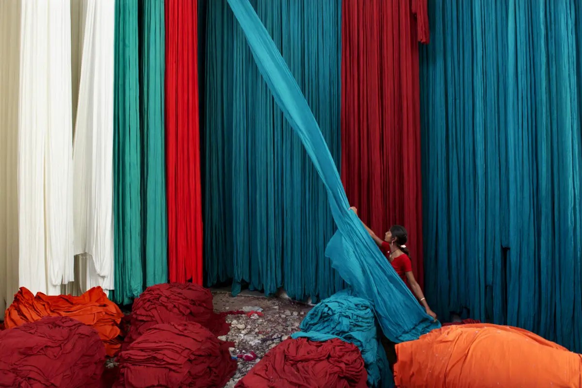 Jeremy Horner Jodhpur, India A woman makes piles from huge bolts of dyed cotton cloth before it is used in making sarees and other fabrics