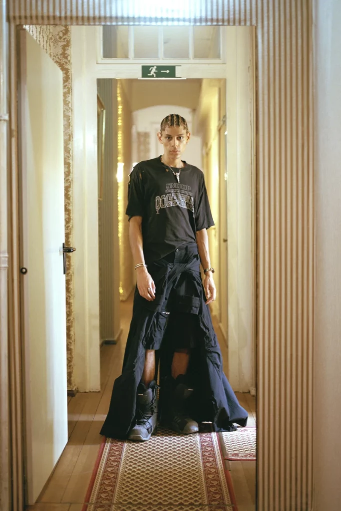 Gavriel wears vintage t-shirt and boots, shorts and coat tied around the hip MM6 Maison Margiela, necklace Iden. Photography Frederik Rüegger, styling Léon C. Romeike