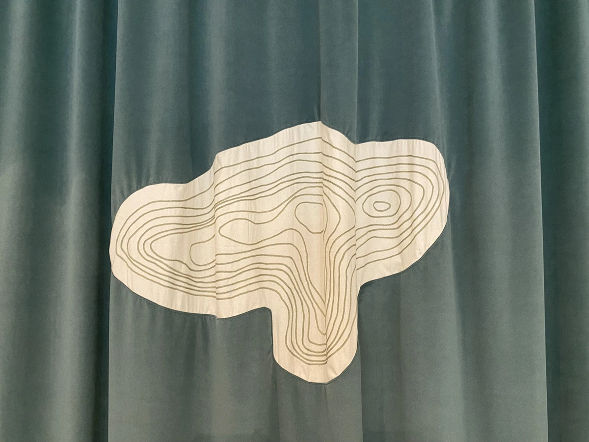A topographical map of Sulaiman-Too mount on the curtain that introduces A Seed Under our Tongue, Saodat Ismailova’s exhibition at Pirelli HangarBicocca