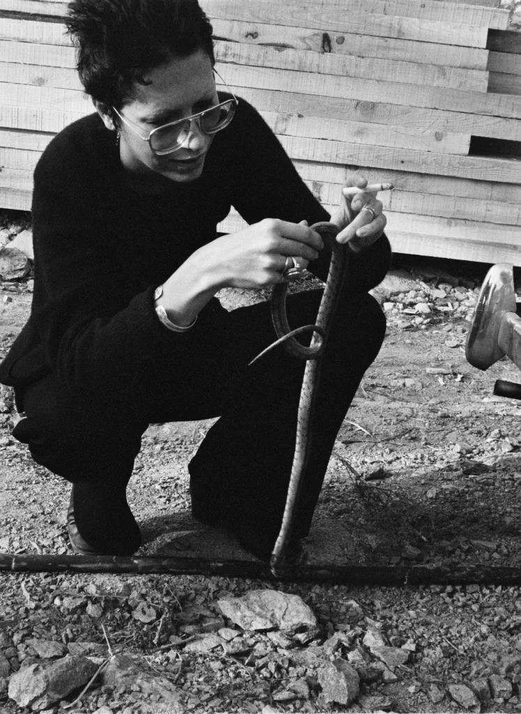 Elsa Peretti studying a snake. Costa Brava, 1970 ©Archivo Colita Fotografía