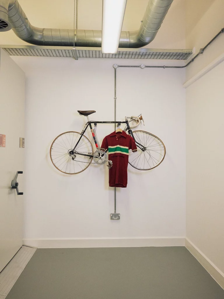 on the wall, the crashed bike: Paul Smith was 17 years-old when he had a bike accident that ended his cycling carreer. Afterwards, he decded to become fashion designer.
