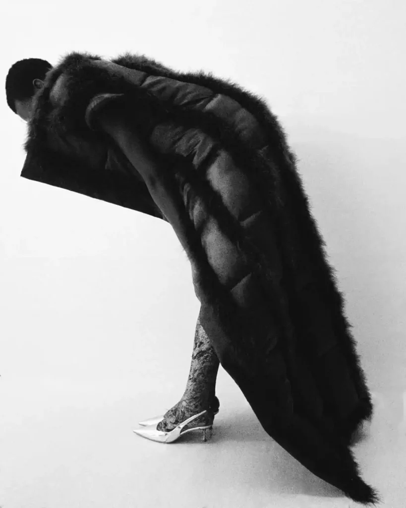 Sikhokhele wears feather gilet Viviers , vintage tights Saint Laurent, vintage shoes