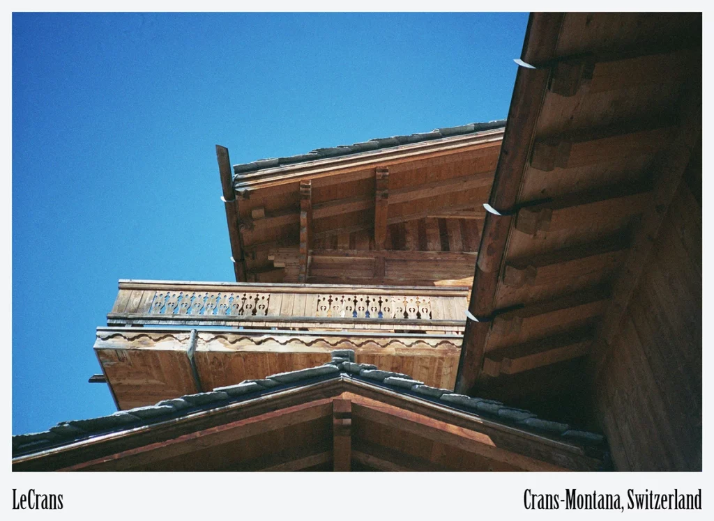 LeCrans, Crans-Montana — upward view of layered Alpine rooflines engineered for heavy snow loads and energy efficiency