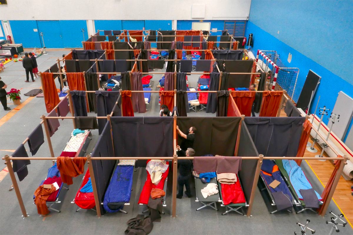 Lampoon, Shigeru Ban's Paper Partition System across temporary shelters in Europe housing Ukrainians