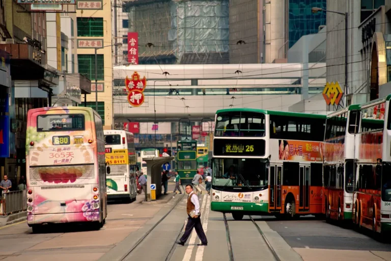 A man crossing tram lines on Hong Kong Island