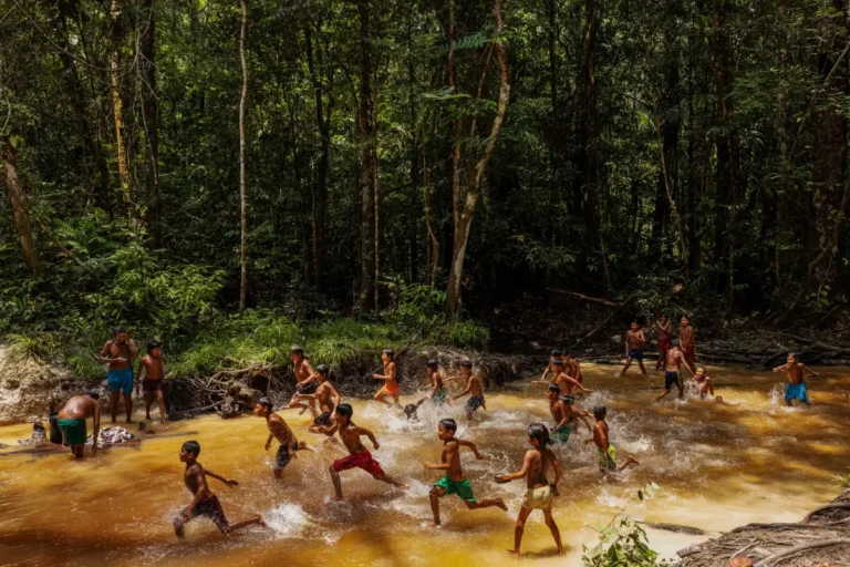 Lampoon Adults and children play in a stream near Mynawa village on Waimiri-Atroari Indigenous Land during a break from a meeting held to discuss issues related to threats to their territory