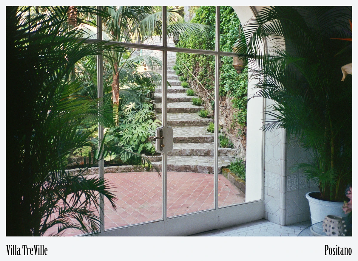 Arched shuttered window capturing morning light recalls the villa’s origins as a private residence