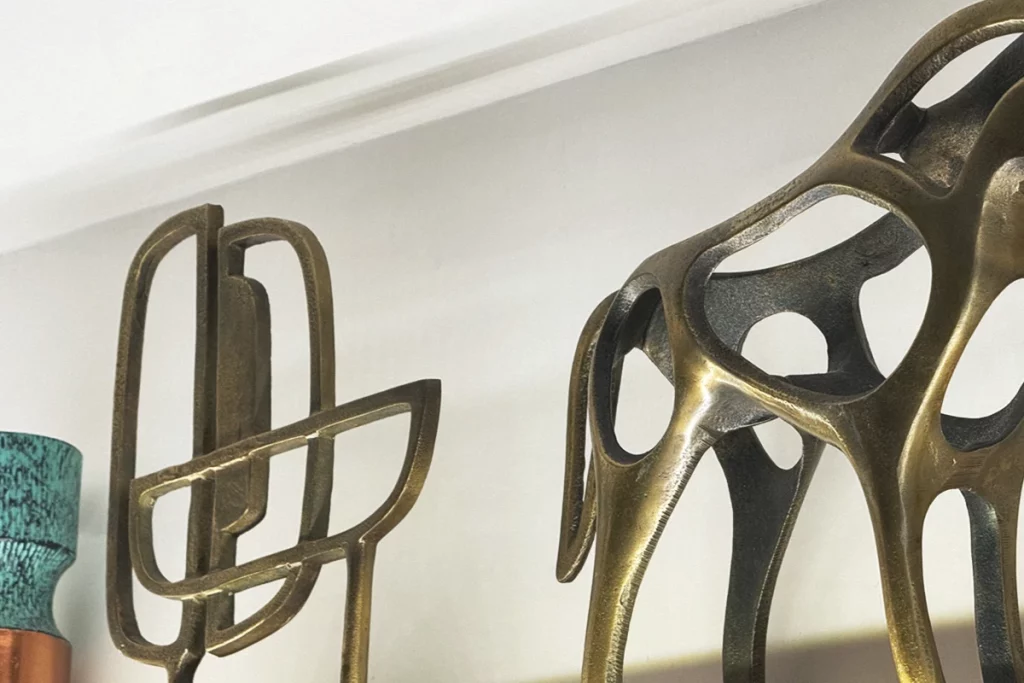 Brach Paris, circulation core – Starck’s sculptural brass screen echoes Bauhaus geometry while softening the concrete bones of the former postal depot.