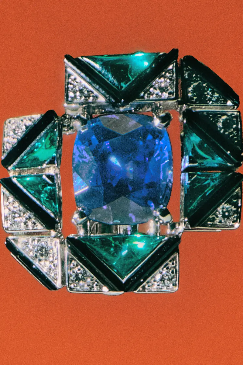 Cartier white gold Mirragio earrings with a sapphire from Ceylon, emeralds, onyx and diamonds. Photography Anna Pogossova