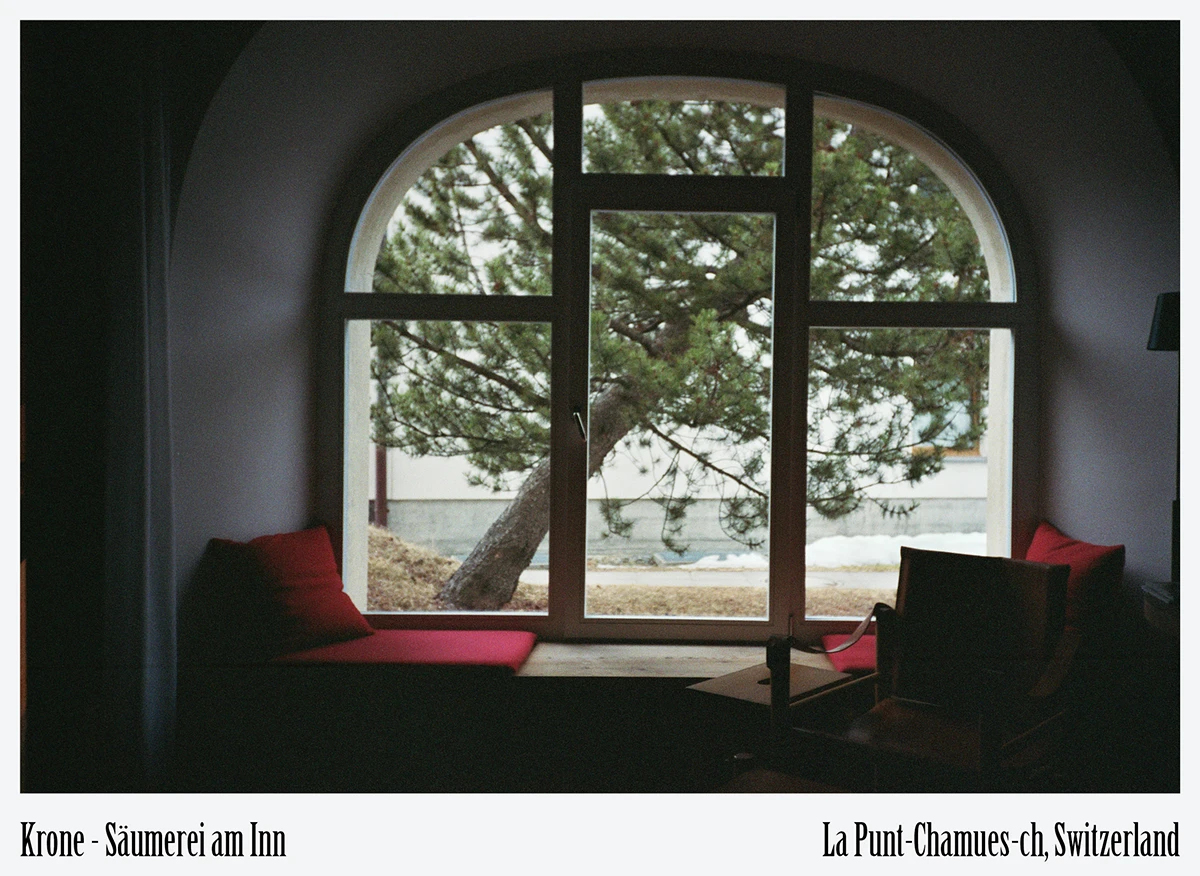 Cozy reading niche beneath arched historic window at Krone La Punt Engadin