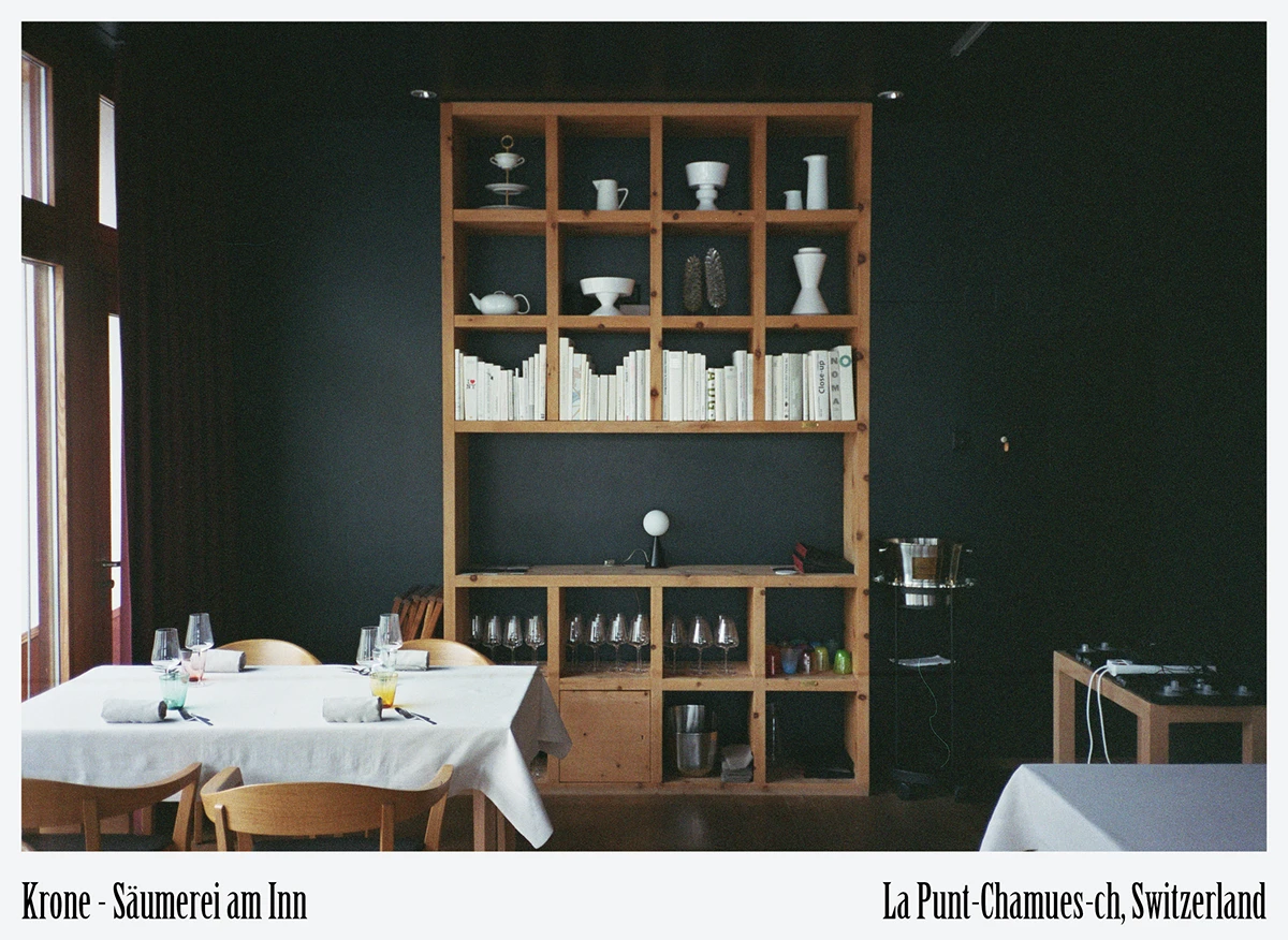 Custom ash-wood shelving showcasing local ceramics and books at Krone La Punt