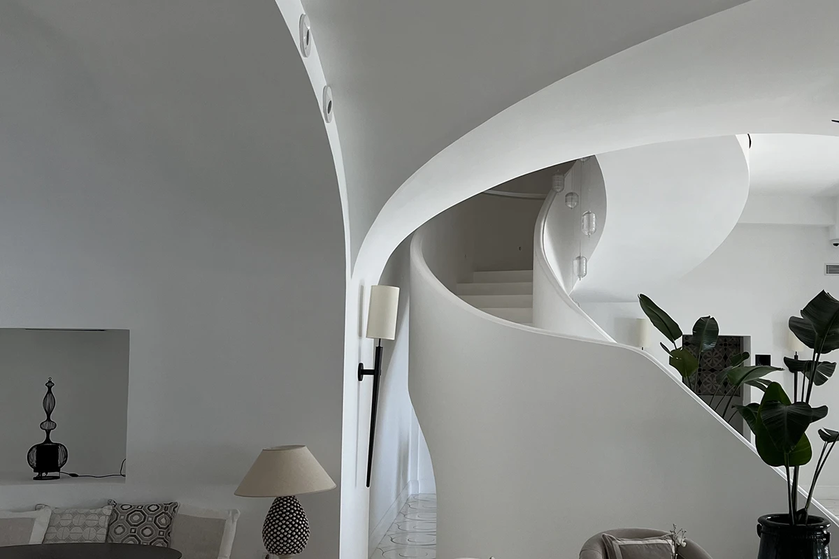 Furore Grand Hotel, sculptural white staircase softly washed in light