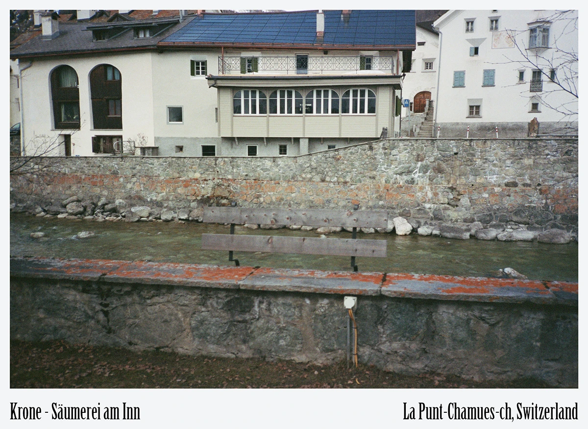 Historic Engadin stone façade on the River Inn at Krone La Punt eco-hotel exterior