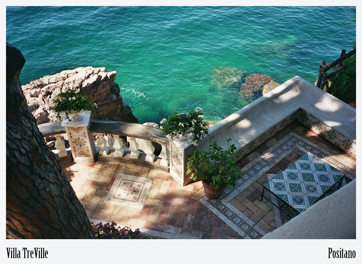Lime-plastered walls and terracotta eaves frame the Amalfi horizon, echoing regional building traditions
