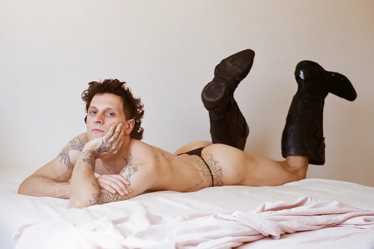 Luca wears boots Balenciaga, thong Hom.Photography Gianmarco Onofri, styling Christian Stemmler