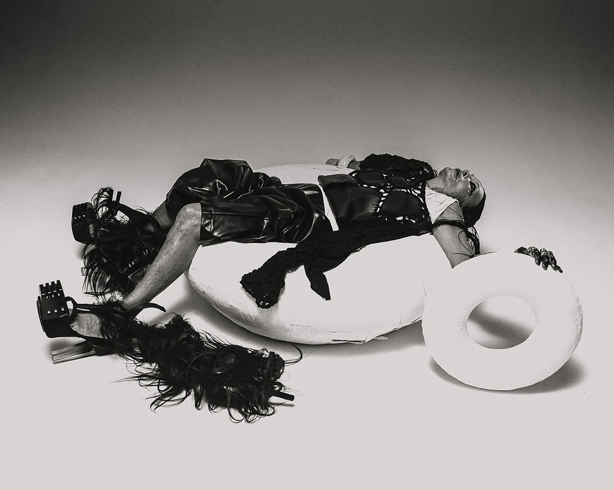 Michèle Lamy shoot by Tarek Mawad, styling Calvin Nymon. T-shirt, leather sweater and shorts Commes Des Garçons, fur boots Rick Owens, jewels and bandana talents own