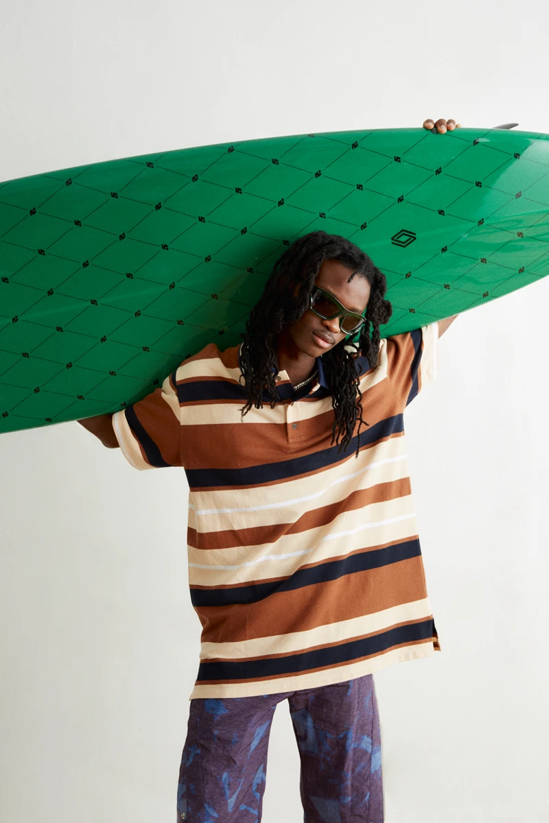 Polo and sunglasses Loewe, short Bluemarble, necklace Louis Vuitton, surfboard Renault. Photography Jeanne Lucas, styling Alexandra Conti