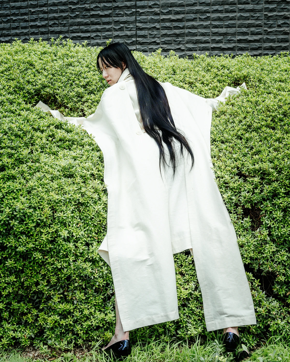 Ramona Deckers - Tokyo - coat, vest, top Issey Miyake, heels stylist's archive