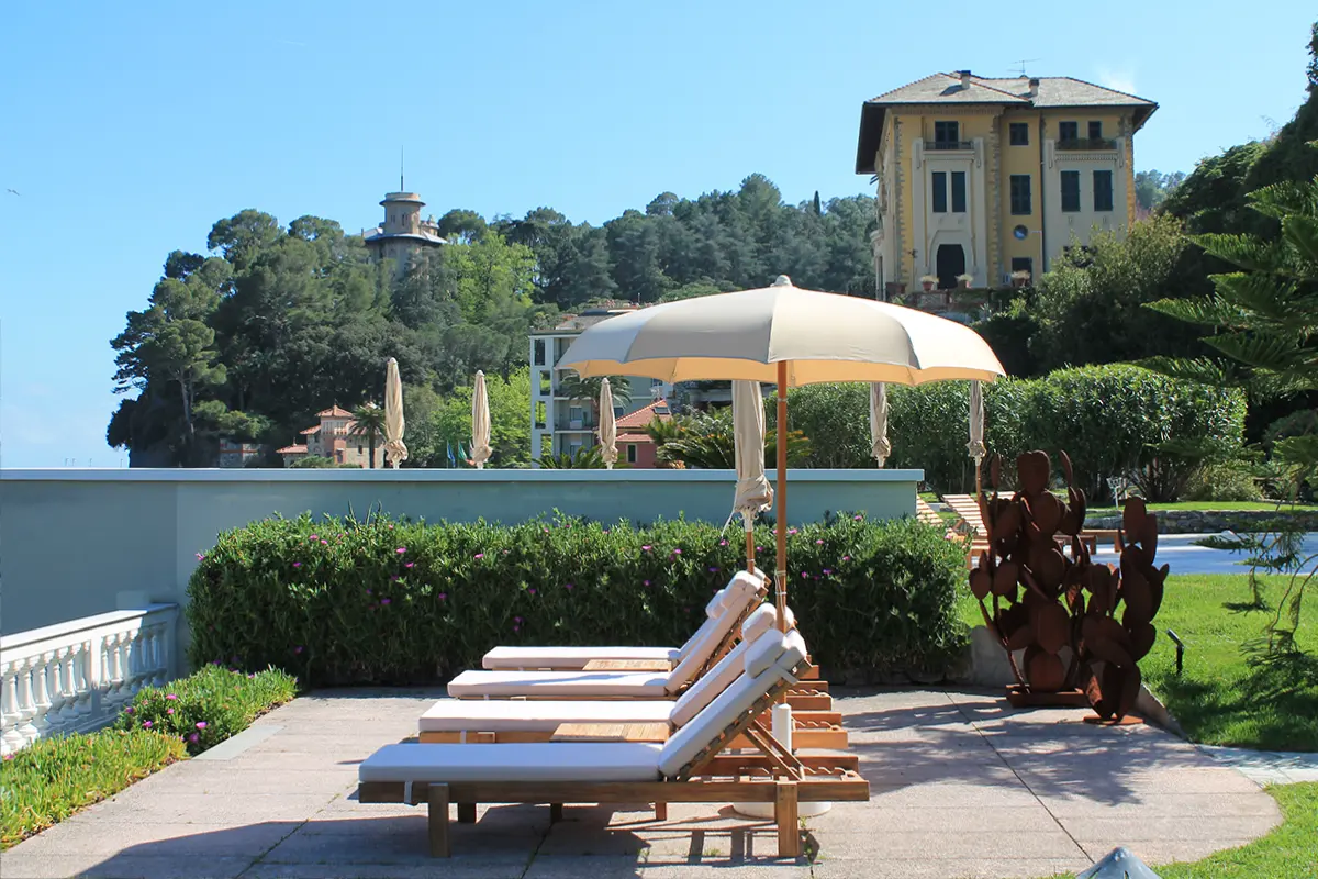 Sideview of sunbeds over Santa Margherita villas at Grand Hotel Miramare outer space