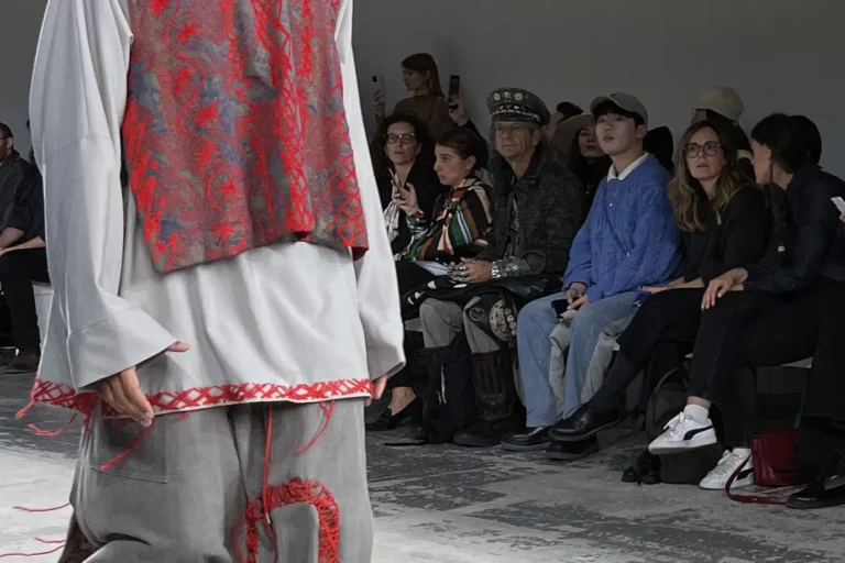 Spectators watching Andrea Lolato's design coming down the runway