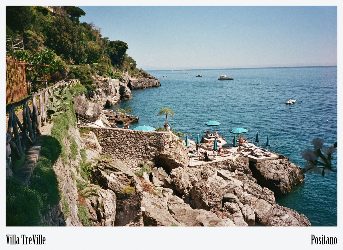 Vietri-tiled landing and steps descend toward turquoise water, illustrating craft manufacturing and careful drainage on steep ground