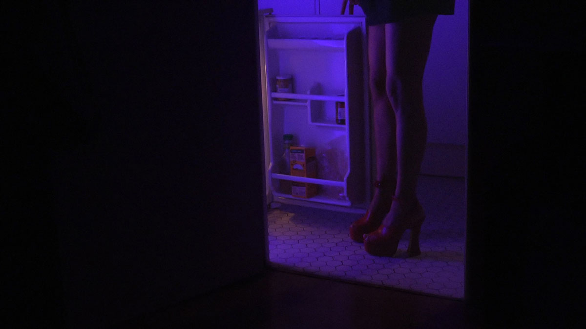 Neon lights in a frame from the video 'In my room' directed by Mati Diop, Miu Miu, Women's Tales