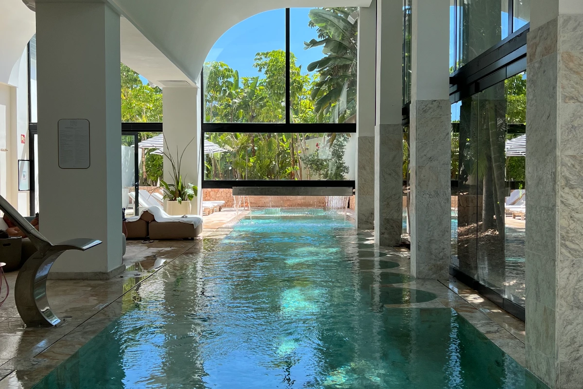 Indoor spa corridor with natural light and water reflections