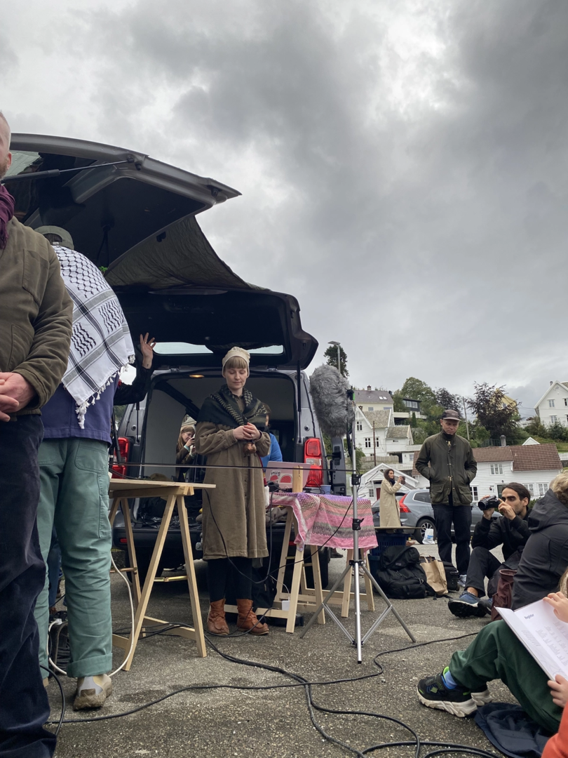 Elin Már Øyen Vister and their team creating an offering to the sea despite the Bergen rain. Photo by Annalise June Kamegawa