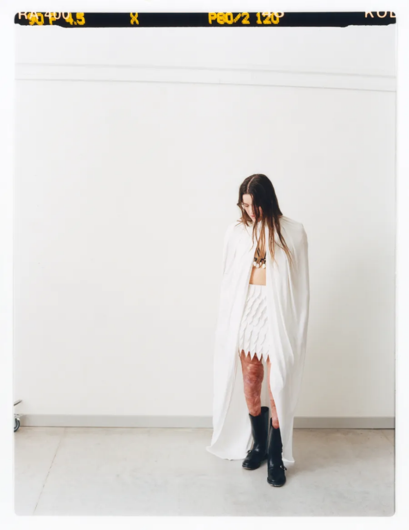 Veronica wears cape Dior, skirt Boss, shoes Durazzi, necklace Monies