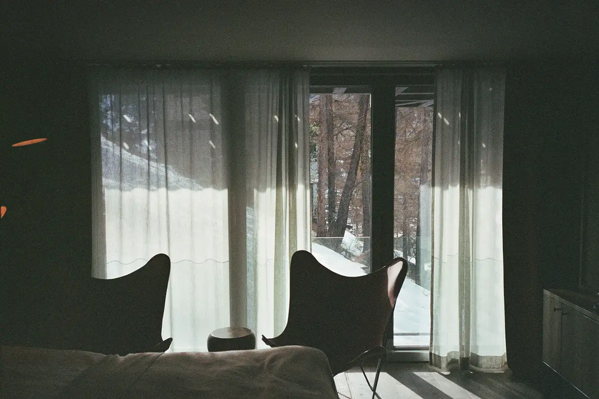 Zermatt. Twin butterfly chairs face floor-to-ceiling alpine views. Cervo Mountain Resort