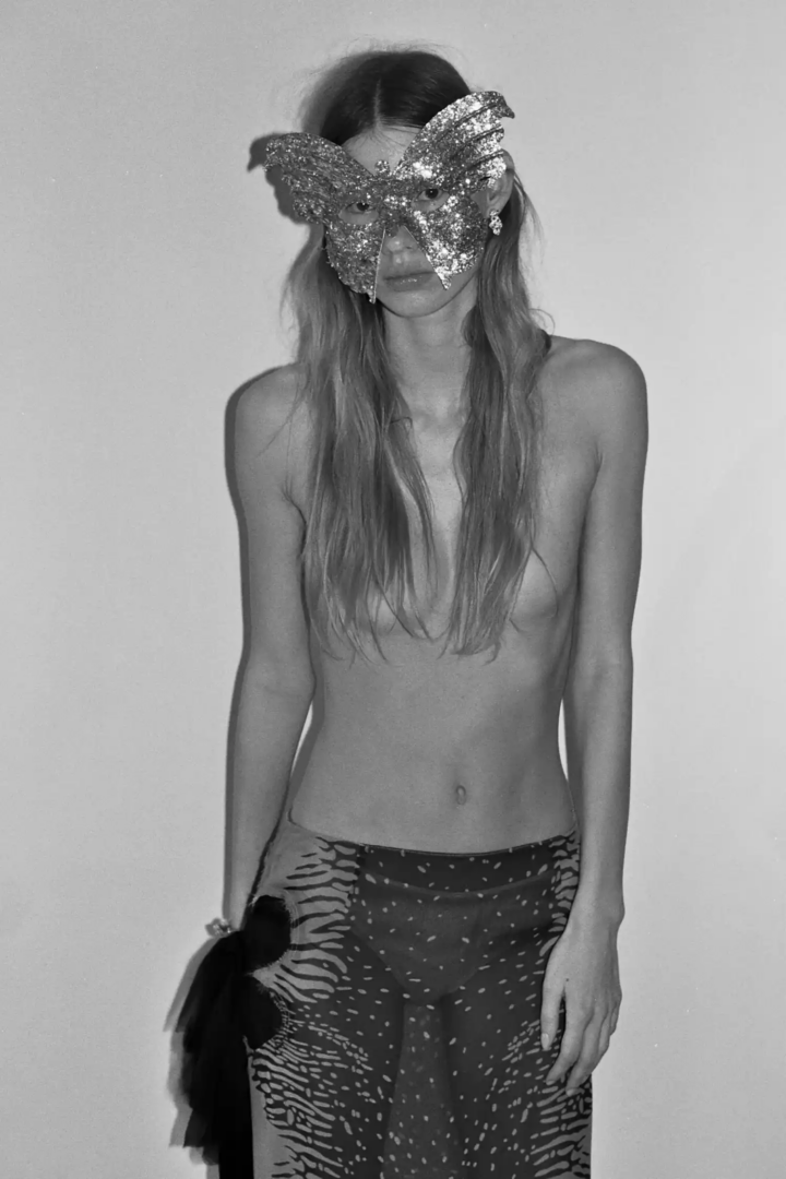 Skirt Ferragamo, bracelet and earrings Cartier, vintage mask stylist’s own. Photography Oriane Verstraeten, styling Leonie Volk