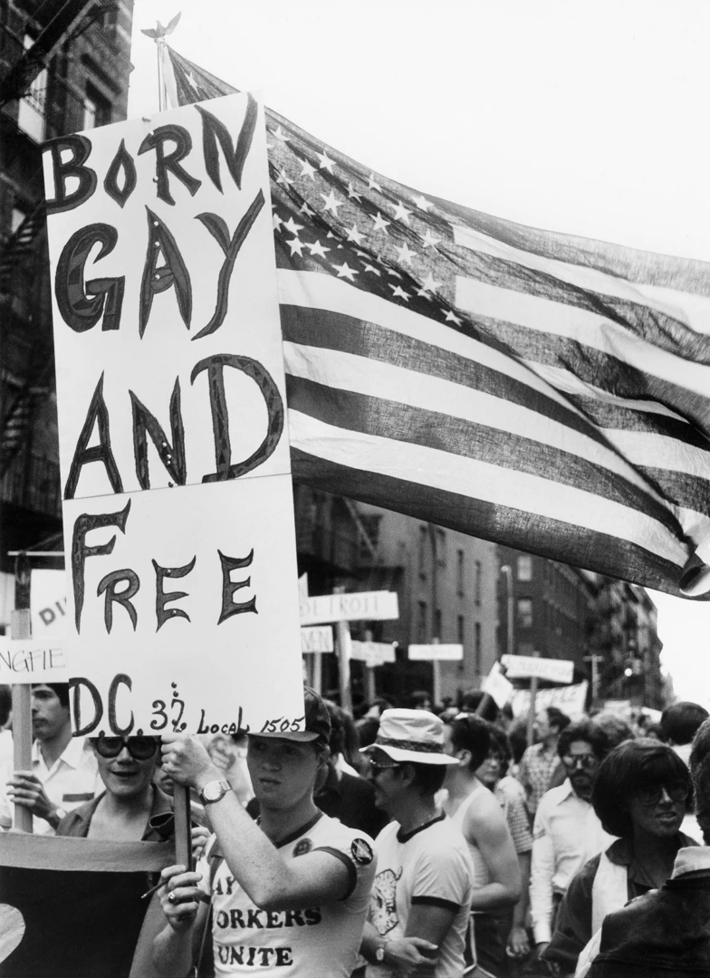 Photograph by Hank O_Neal capturing an activist holding a _Born Gay and Free_ sign at the Christopher Street Liberation Day Parade in New York City, 1974
