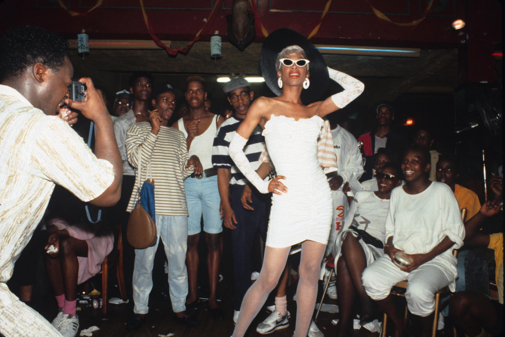 The iconic Octavia St. Laurent commanding the runway at a Harlem ballroom event in New York City, 1988. Captured by Catherine McGann