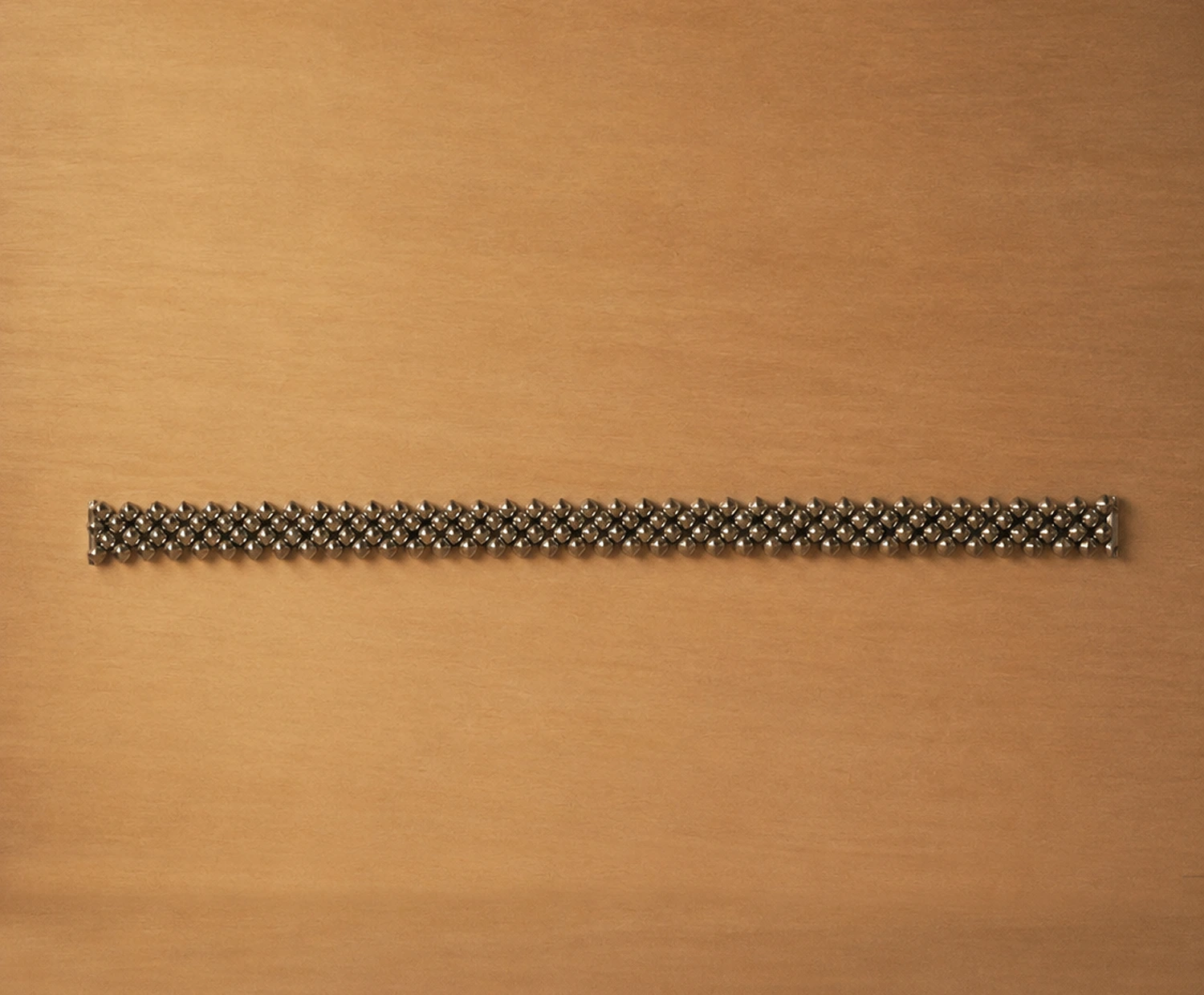 Handcrafted titanium necklace by Lampoon, composed of 164 shield-shaped elements and presented in a custom-designed wooden collector's box with hemp lining