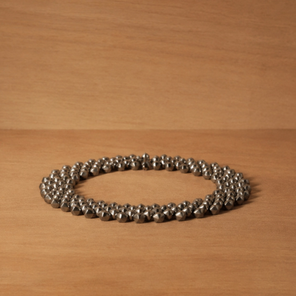 Handcrafted titanium necklace by Lampoon, composed of 164 shield-shaped elements and presented in a custom-designed wooden collector's box with hemp lining