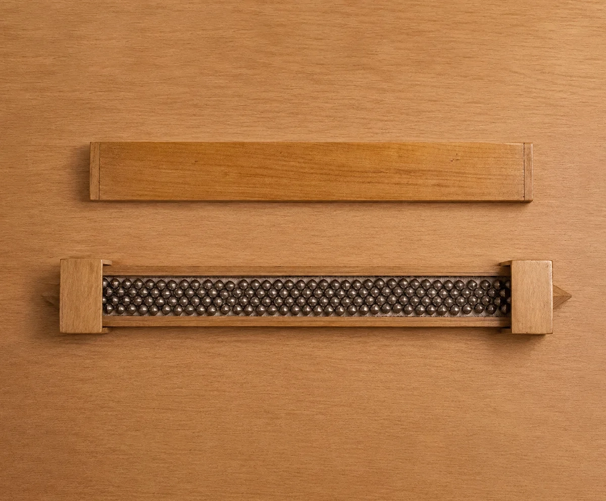 Handcrafted titanium necklace by Lampoon, composed of 164 shield-shaped elements and presented in a custom-designed wooden collector's box with hemp lining