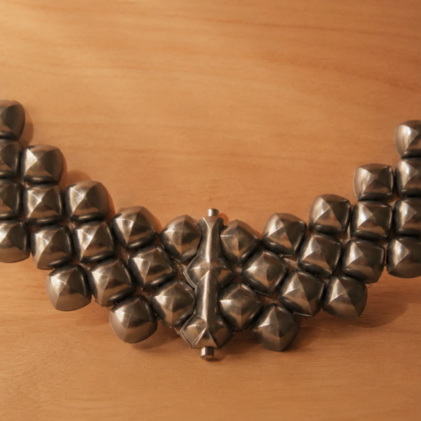 Handcrafted titanium necklace by Lampoon, composed of 164 shield-shaped elements and presented in a custom-designed wooden collector's box with hemp lining