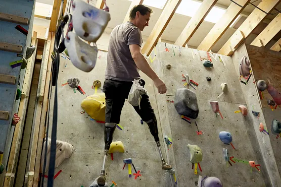 Hugh Herr scaling a climbing wall