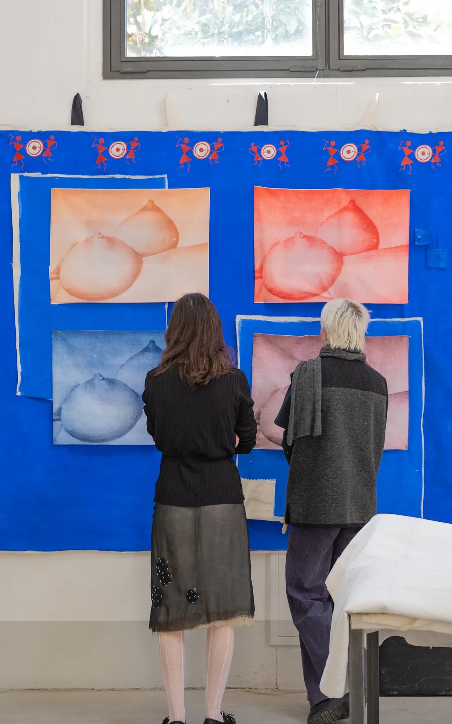 LZ Residency, Photography Darai Efimova. Soft-toned abstract textile artworks mounted on a vivid blue exhibition wall inside a bright gallery space.