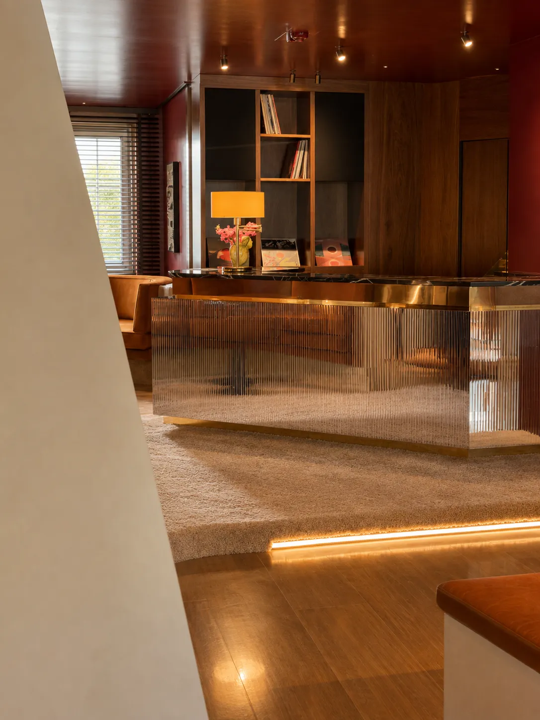 The Listening Bar, where dark walnut, smoked mirrors and lacquered surfaces frame Aurora’s long-standing relationship with music